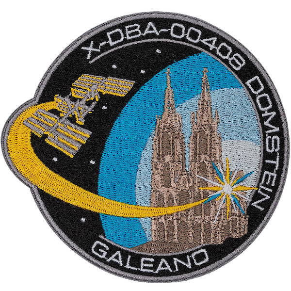 Patch with a graphic of Cologne Cathedral and space travel elements.